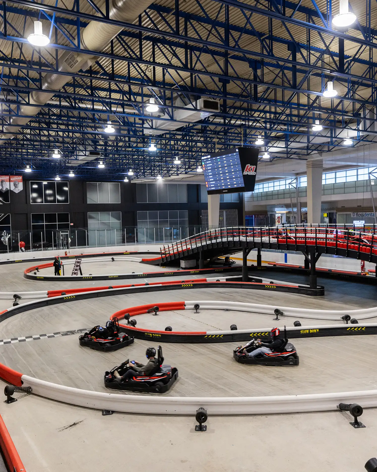 Indoor go-kart track with multiple karts and a beginner-friendly racing layout